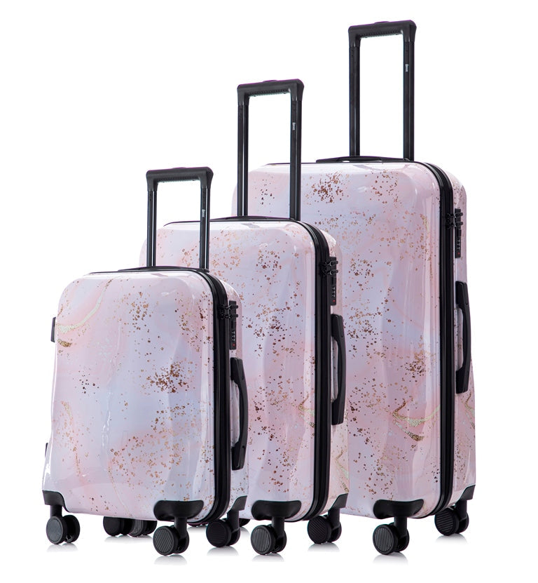 Set of three marble-patterned suitcases with black handles and wheels on a white background