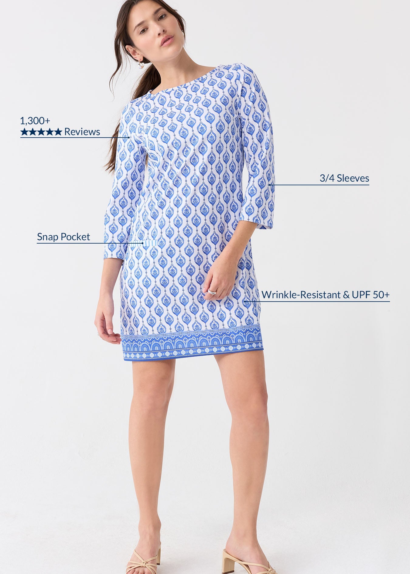 Woman wearing a blue and white patterned dress on a white background