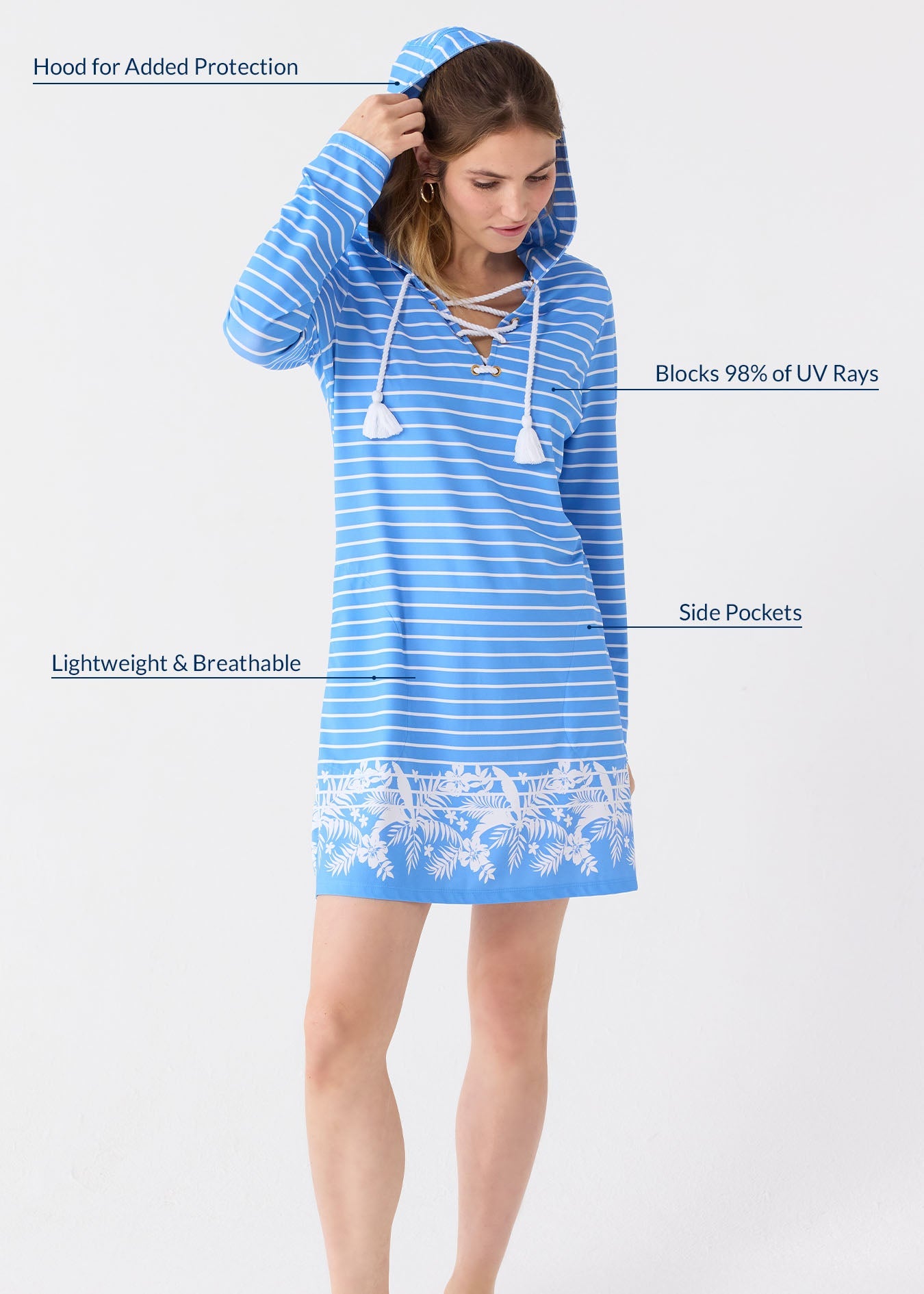 Woman wearing a blue striped dress with hood and lace details, standing against a white background.