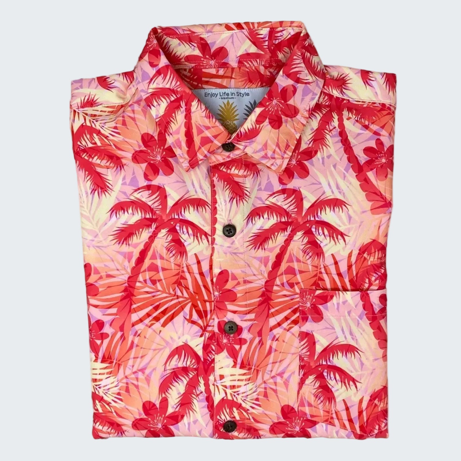 Folded shirt with a tropical palm tree pattern on a white background