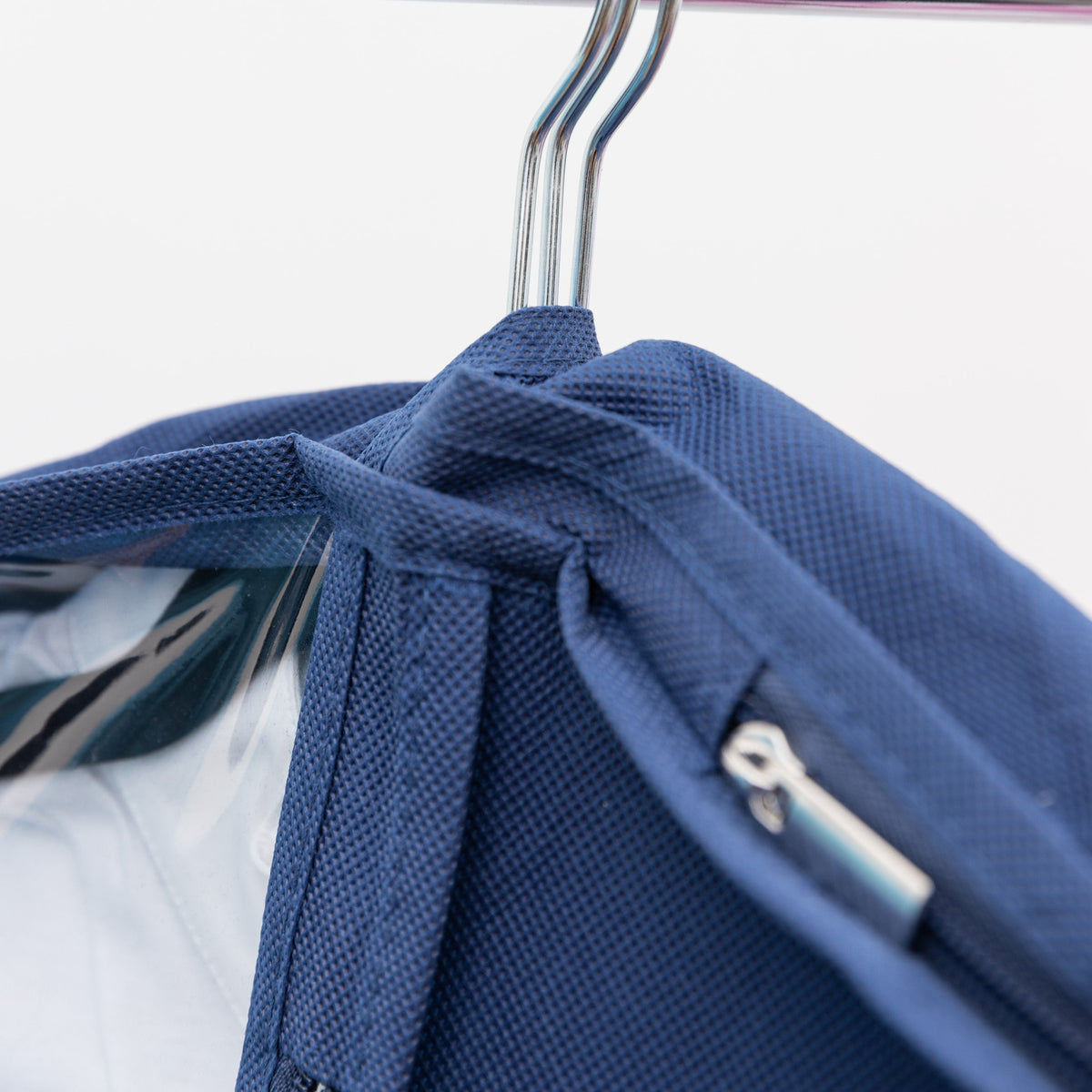 Blue backpack on a hanger against a white background