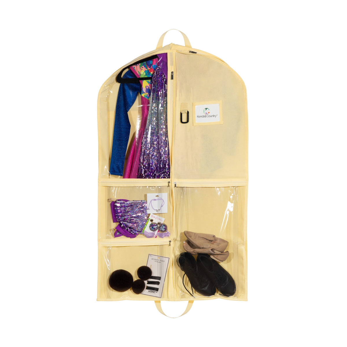 A beige hanging garment organizer with multiple compartments, shown against a white background. The organizer is filled with various items including a blue and purple sequined dress, a blue scarf, a purple fabric item, a pair of beige shoes, and black slippers.