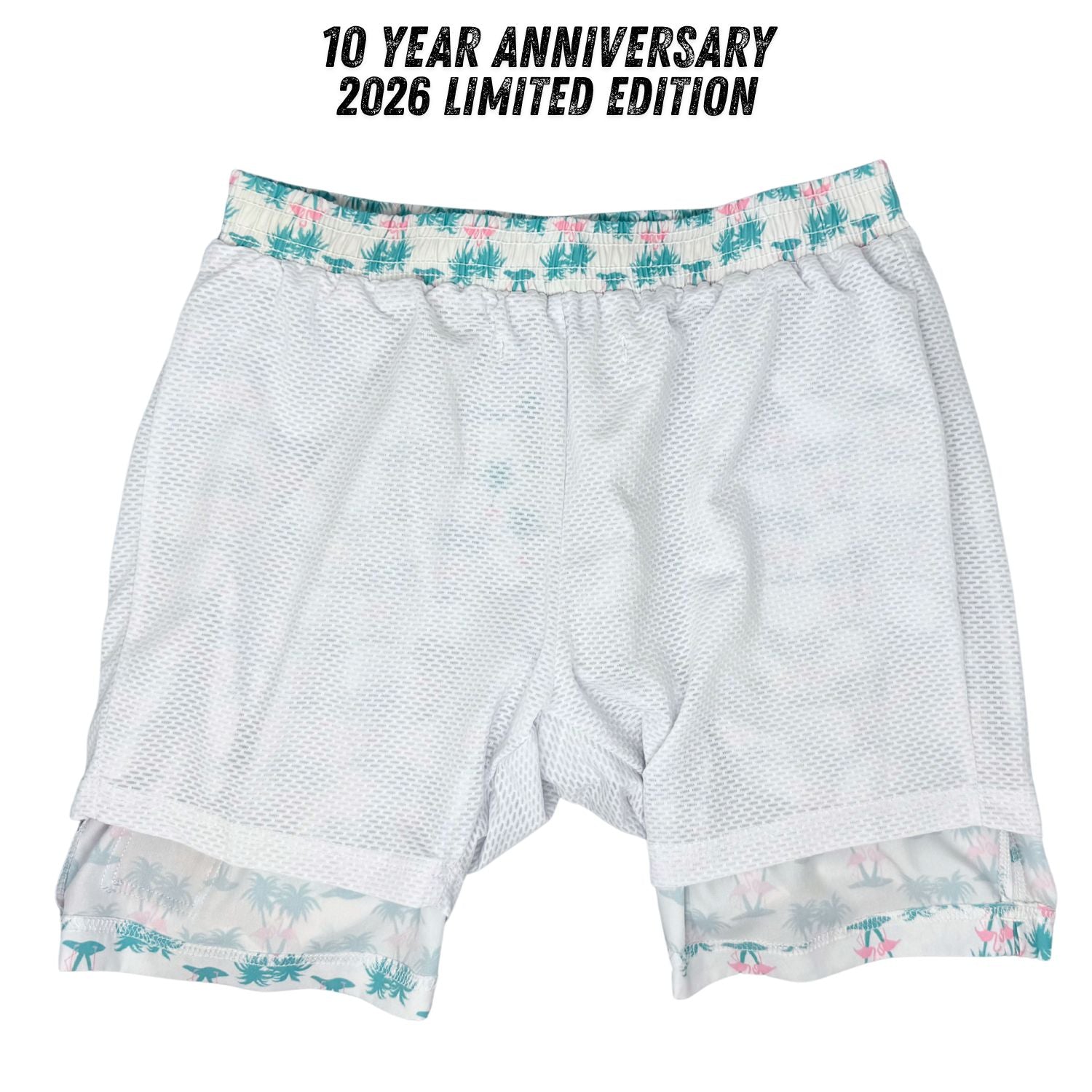 White athletic shorts with floral trim on a white background, featuring '10 Year Anniversary 2026 Limited Edition' text.