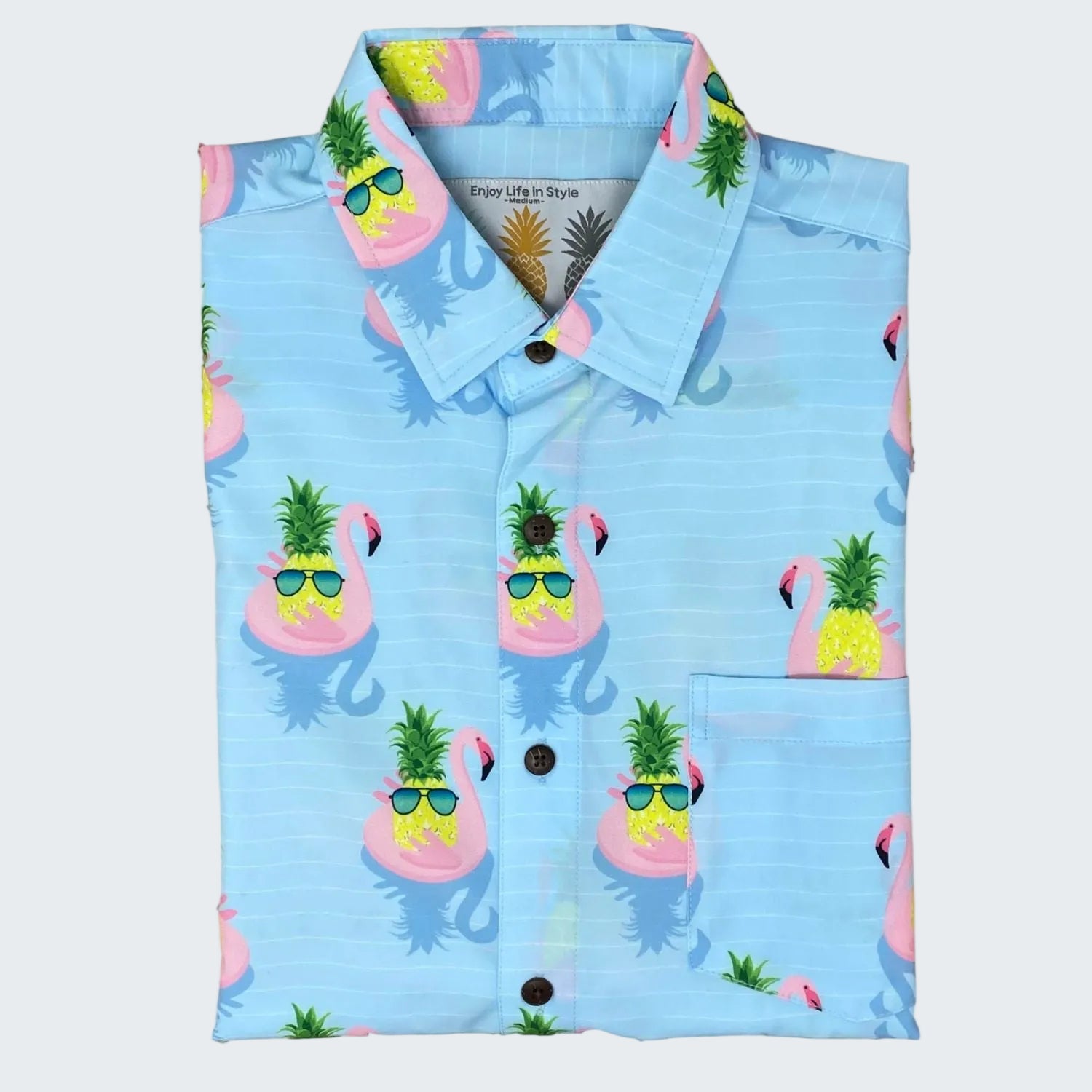 Blue shirt with flamingo and pineapple pattern on a white background