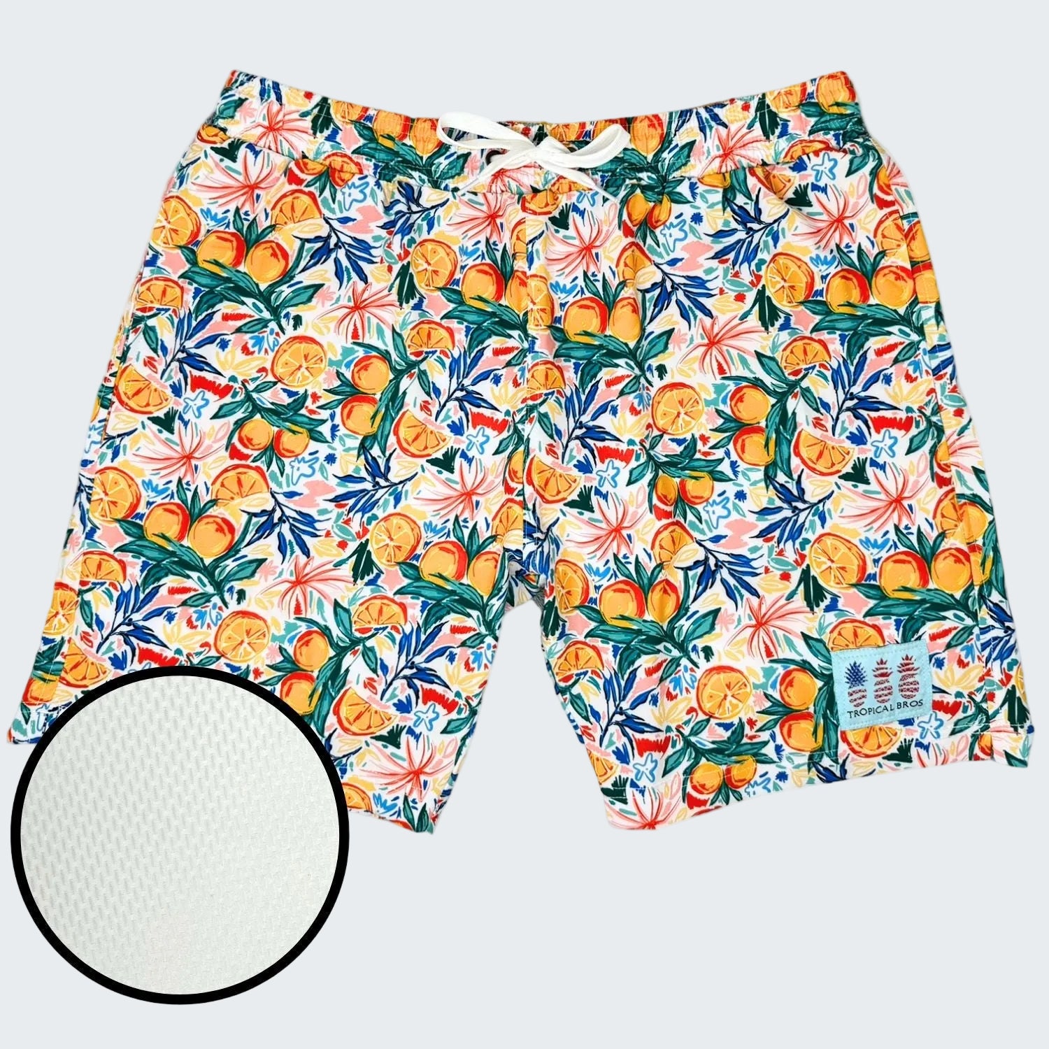 Colorful tropical fruit patterned shorts on a white background