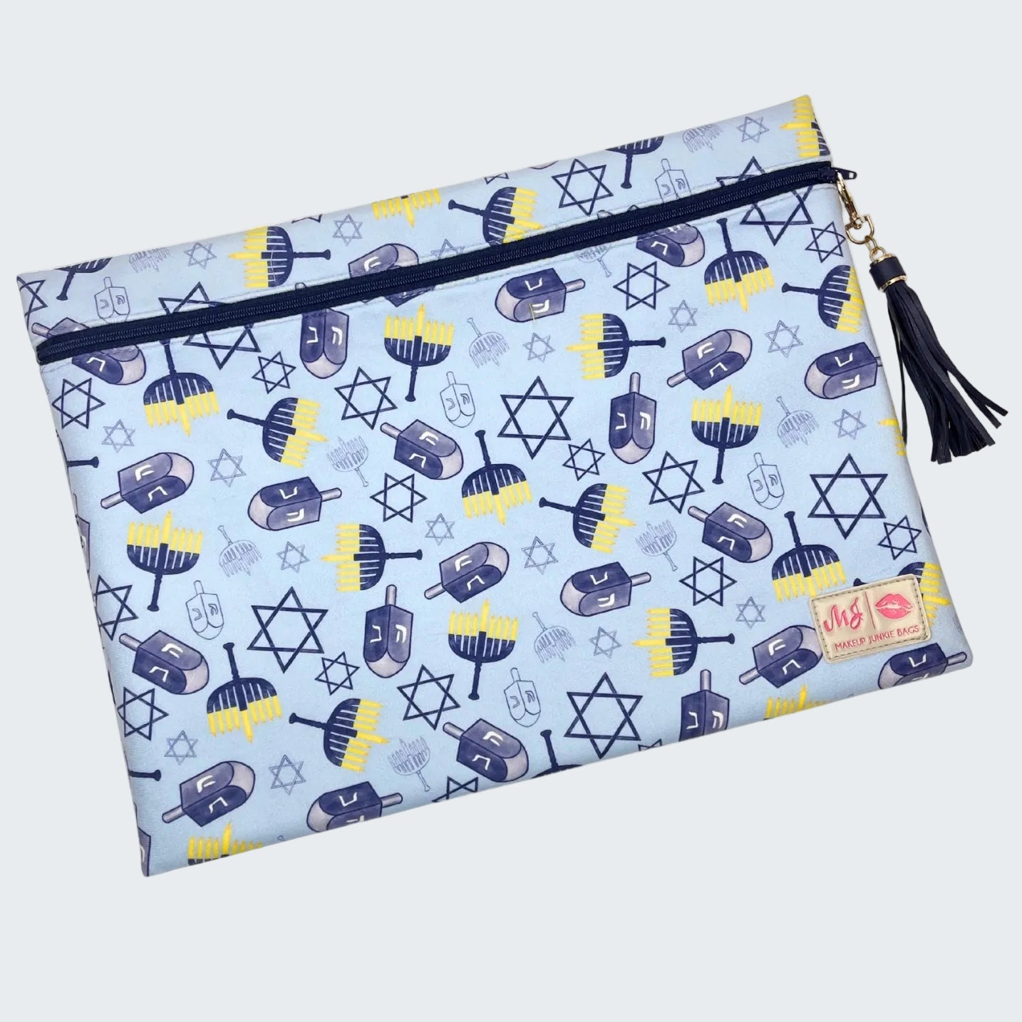 Pouch with Hanukkah-themed design featuring dreidels and stars of David on a light blue background.