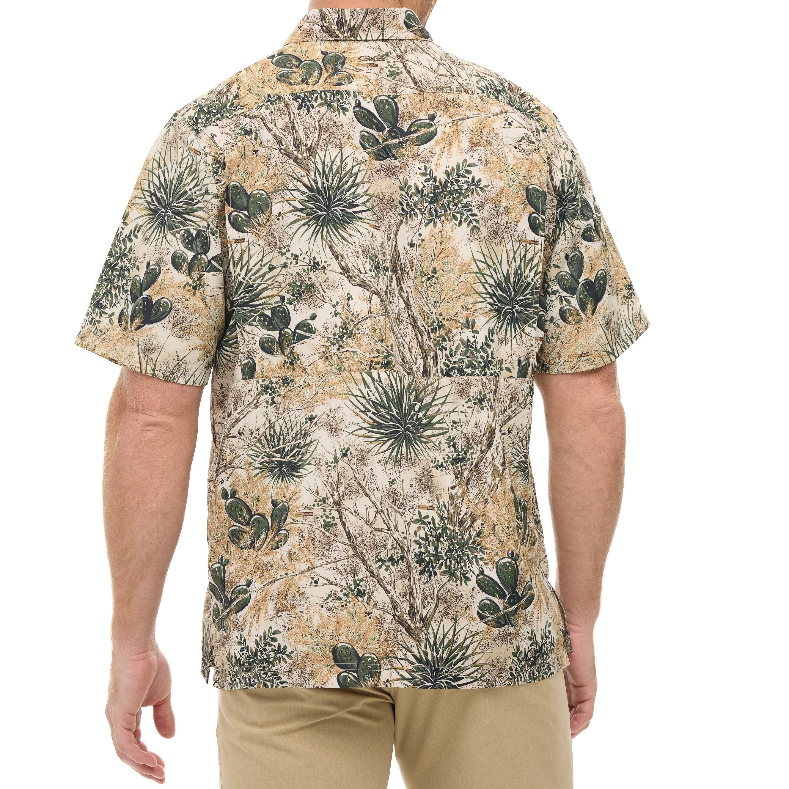 Man wearing a short-sleeve shirt with a cactus and succulent pattern on a white background