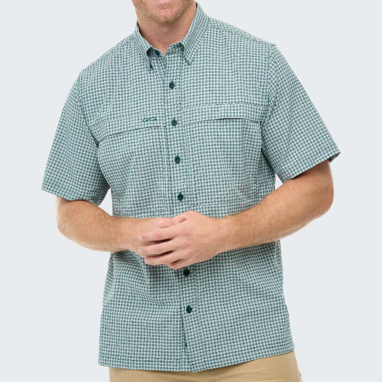 Man wearing a green checkered shirt with a logo on a white background