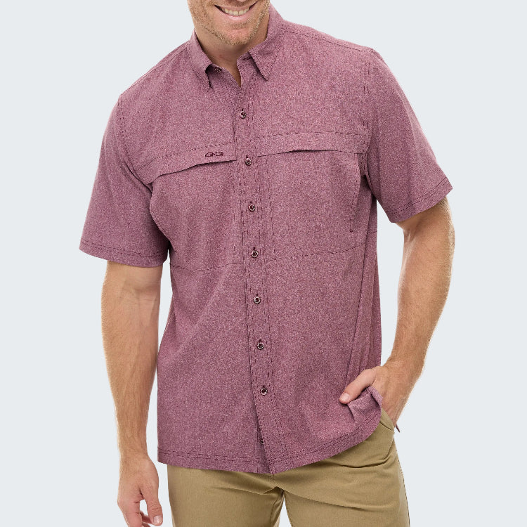 Man wearing a maroon short-sleeve shirt with pockets on a white background