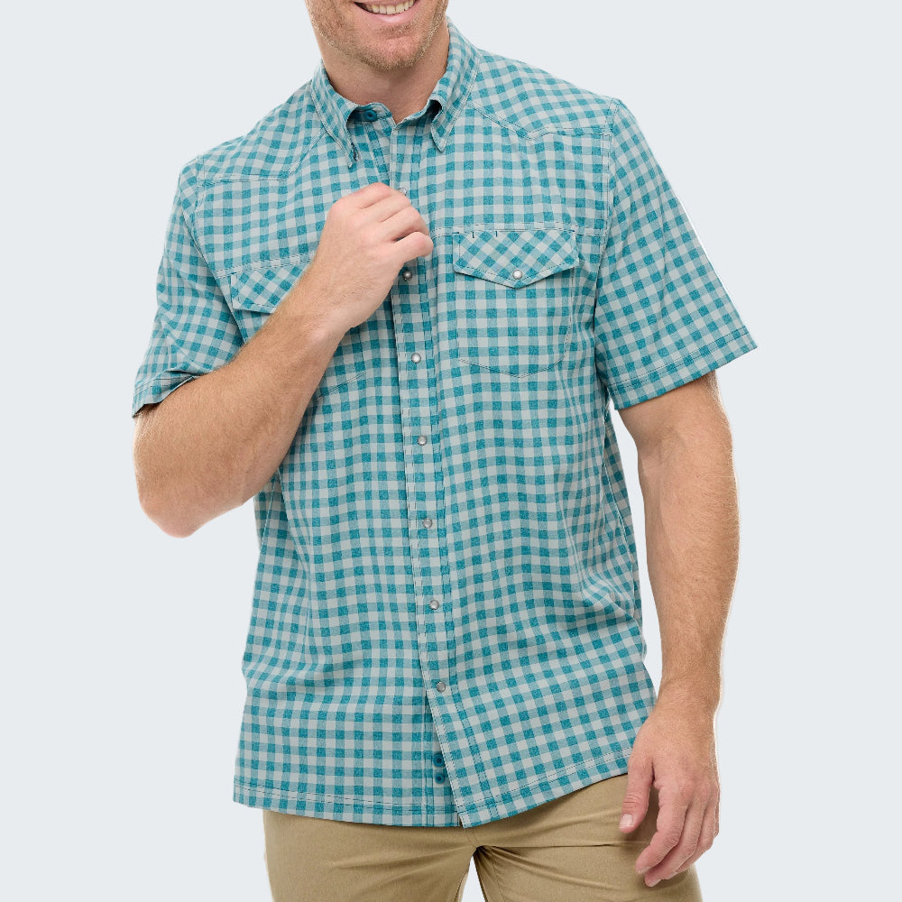 Man wearing a blue and green checkered shirt on a white background