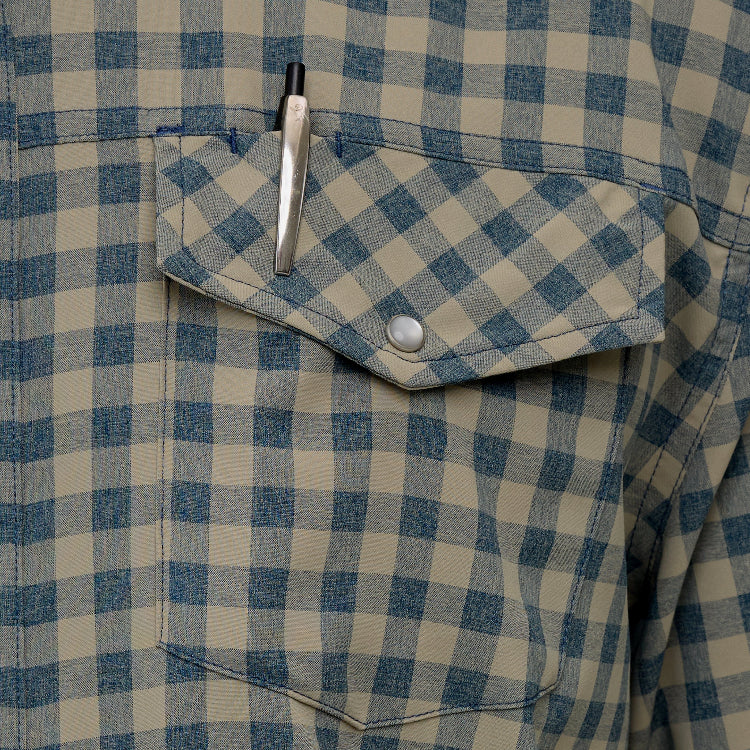 Close-up of a blue and beige checkered shirt with a pen in the pocket.
