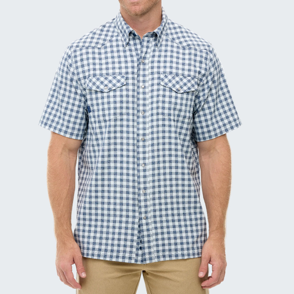 Man wearing a blue and white checkered short-sleeve shirt on a light gray background