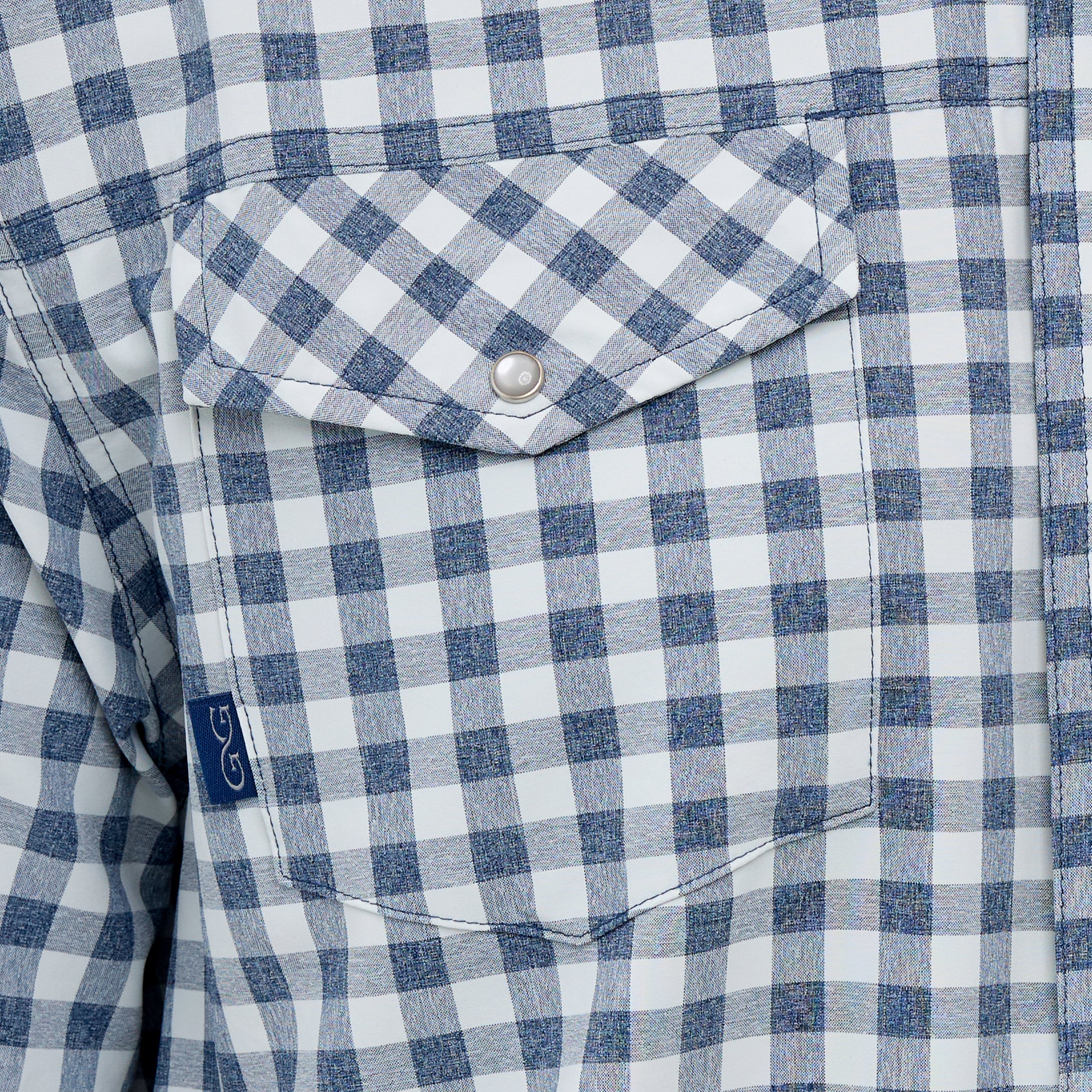 Close-up of a blue and white checkered shirt with a button and collar detail.