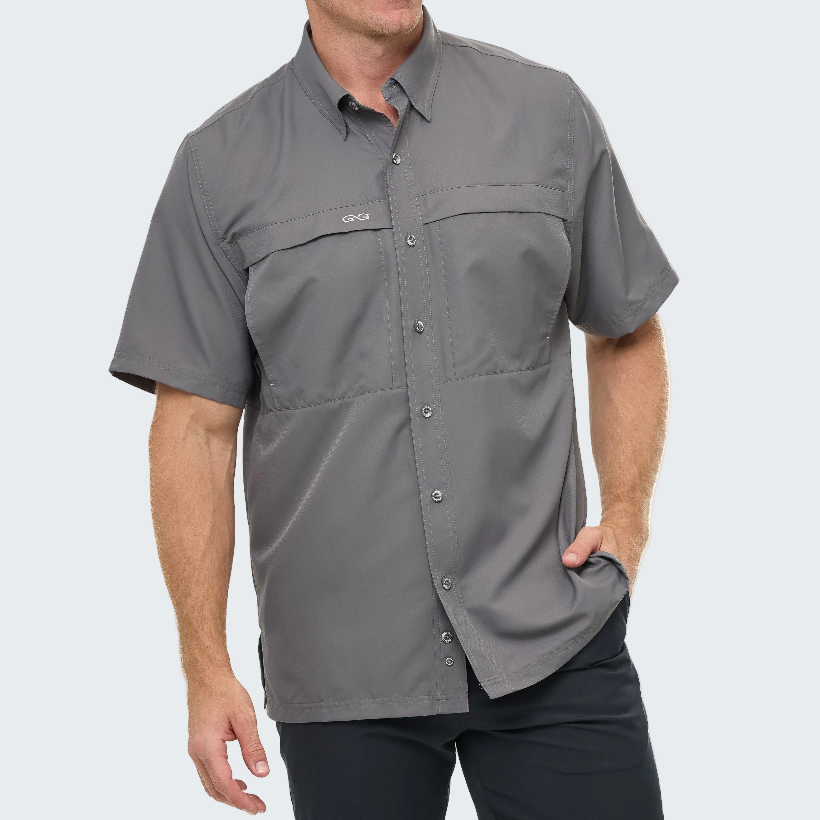 Man wearing a gray short-sleeve shirt with a brand logo on a white background