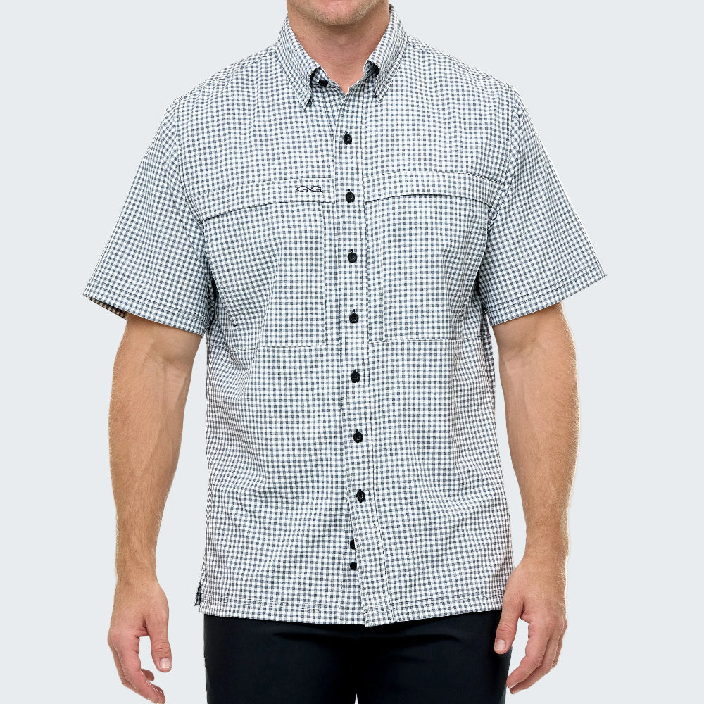 Man wearing a checkered short-sleeve shirt on a light gray background