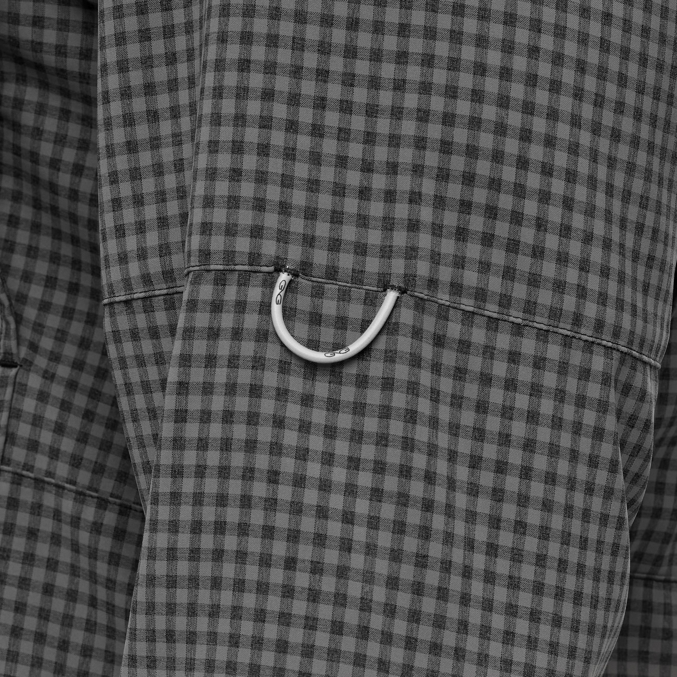 Close-up of a gray checkered fabric with a white button