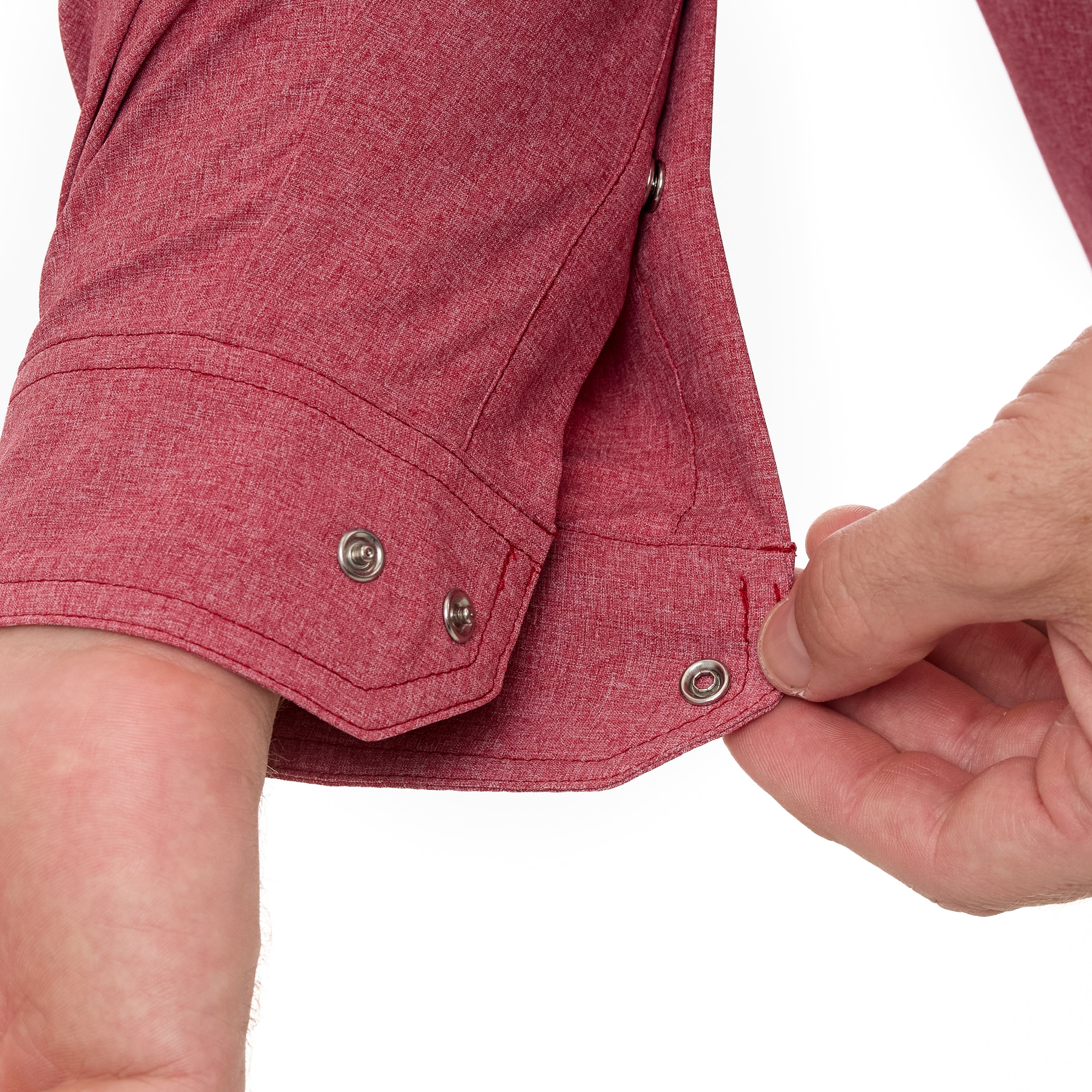 Close-up of a person adjusting the waistband of a red shirt on a white background