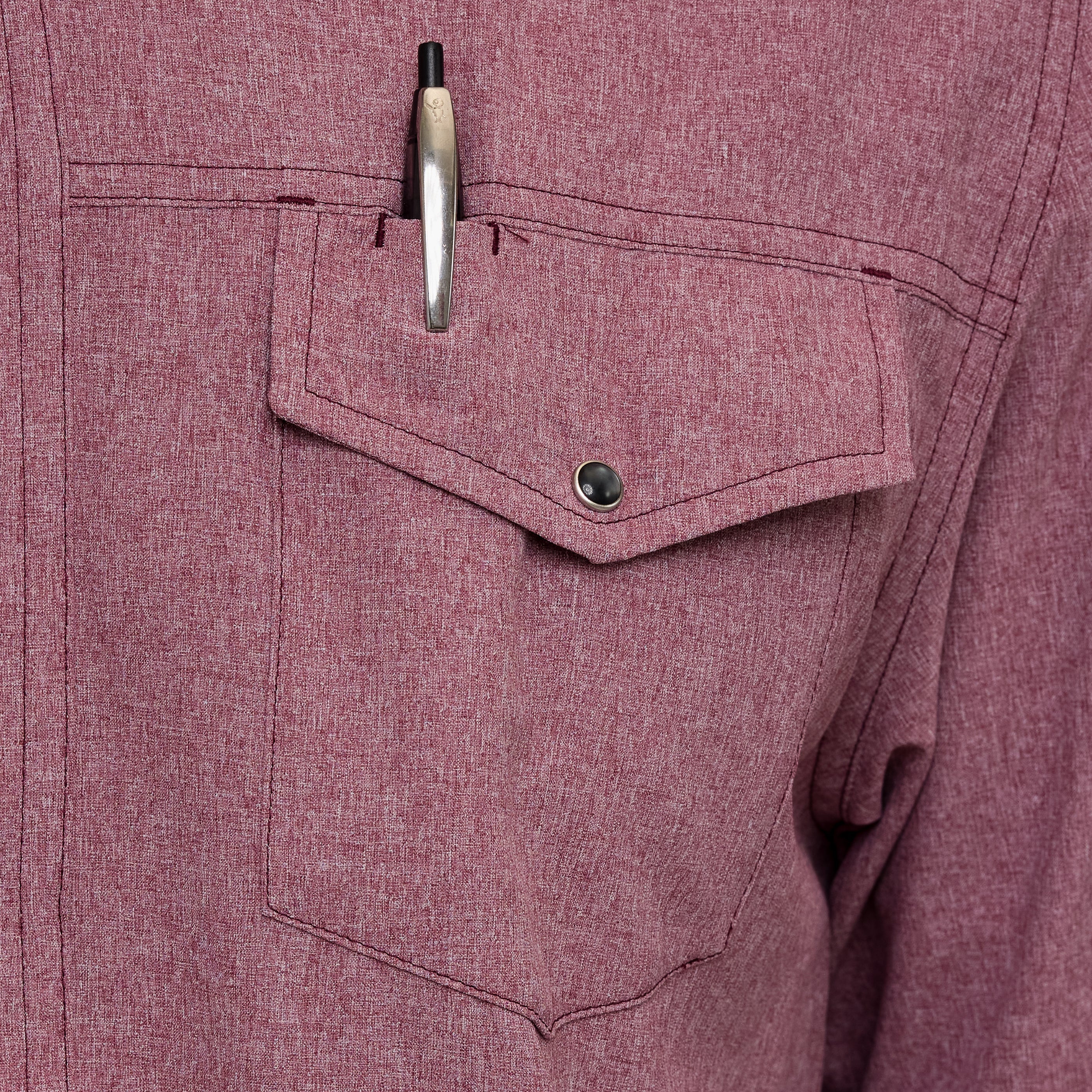 Close-up of a maroon shirt with a pen in the pocket