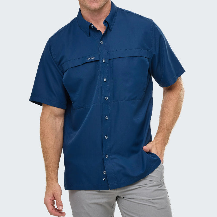 Man wearing a blue short-sleeve shirt with a brand logo on a gray background