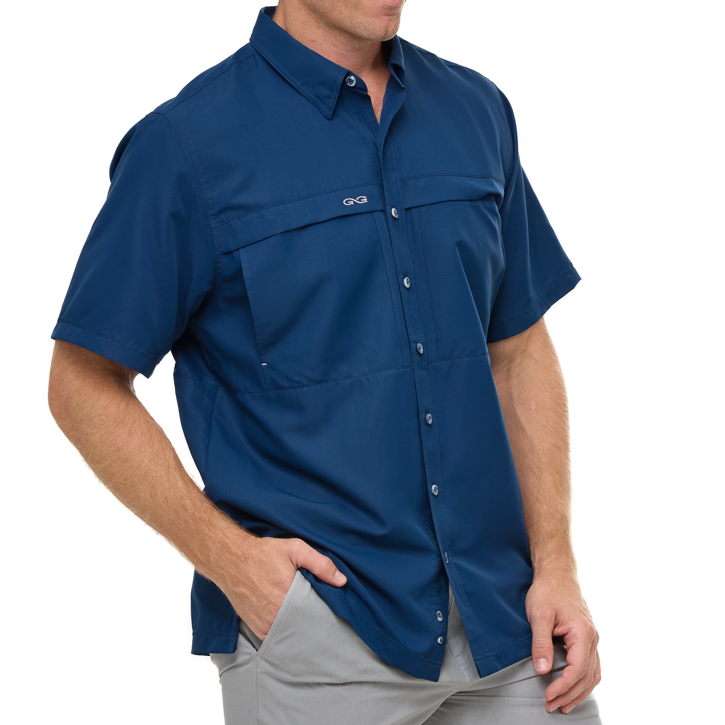 Man wearing a blue short-sleeve shirt with pockets on a white background