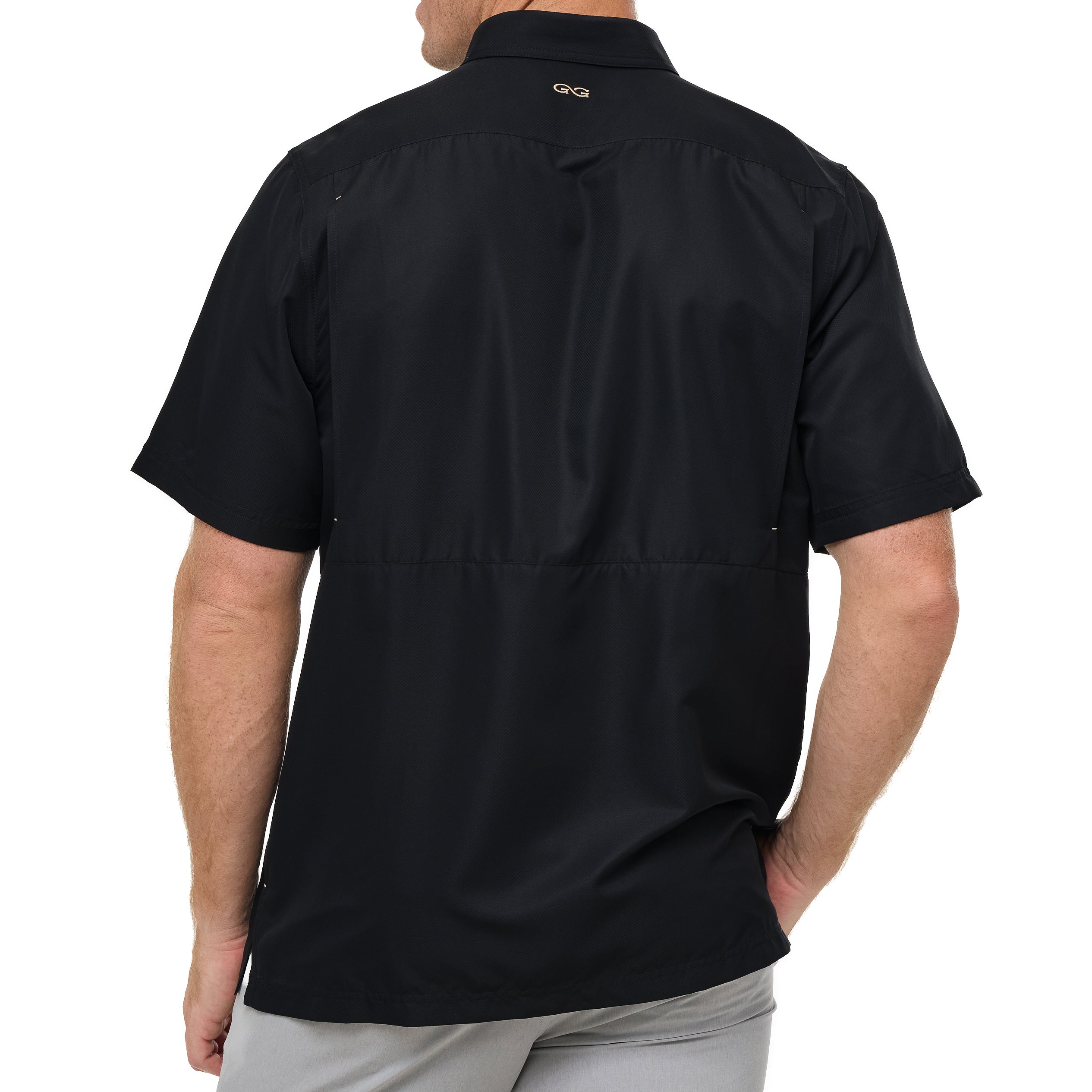 Black short-sleeve shirt worn by a person on a white background