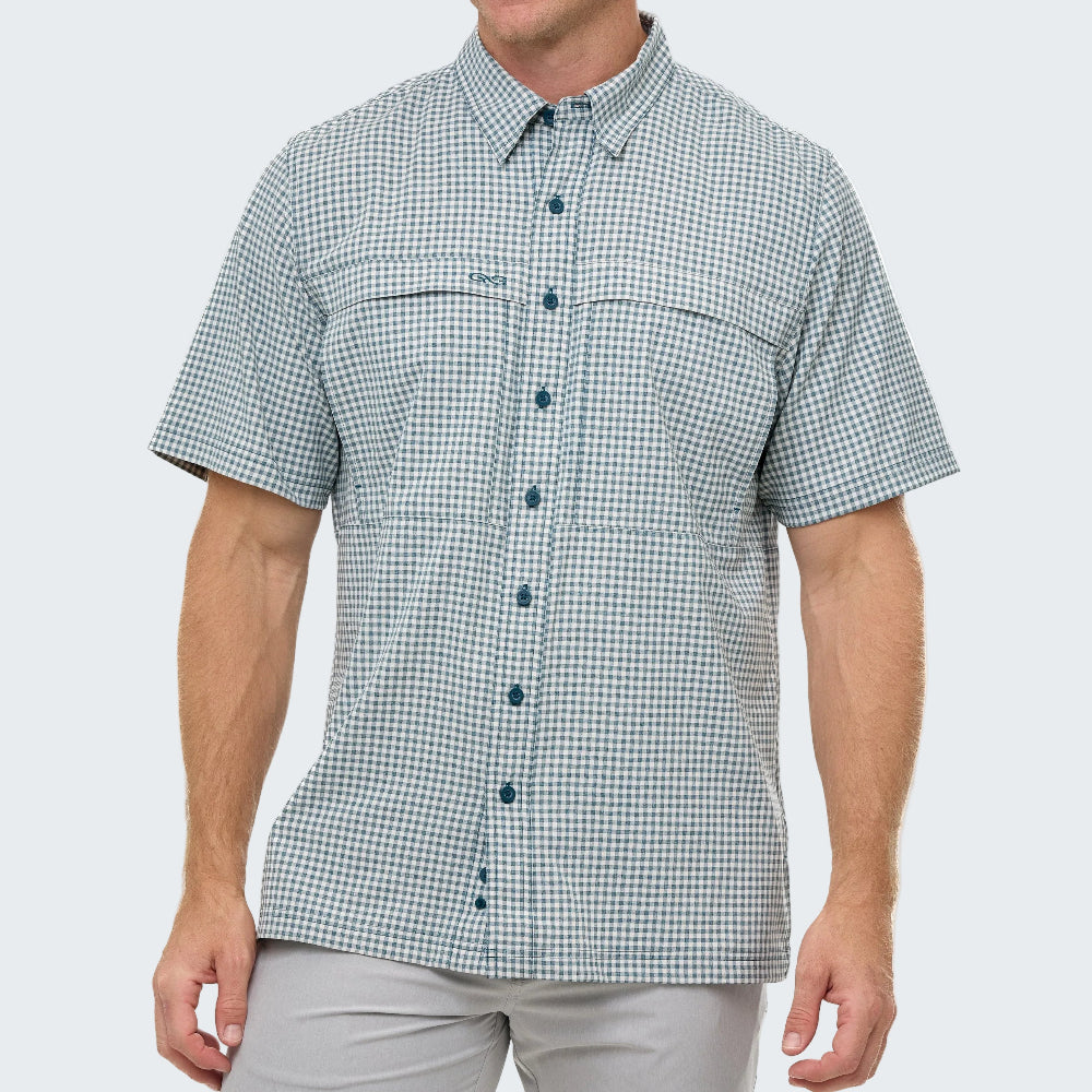 Man wearing a green and white checkered short-sleeve shirt on a light gray background