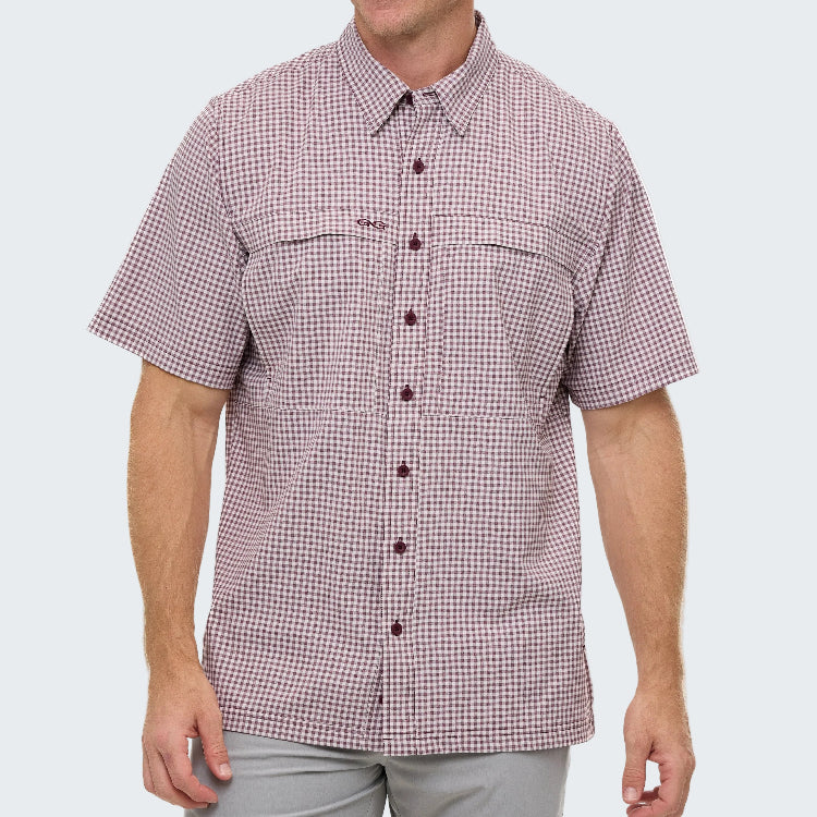 Man wearing a red and white checkered shirt on a white background