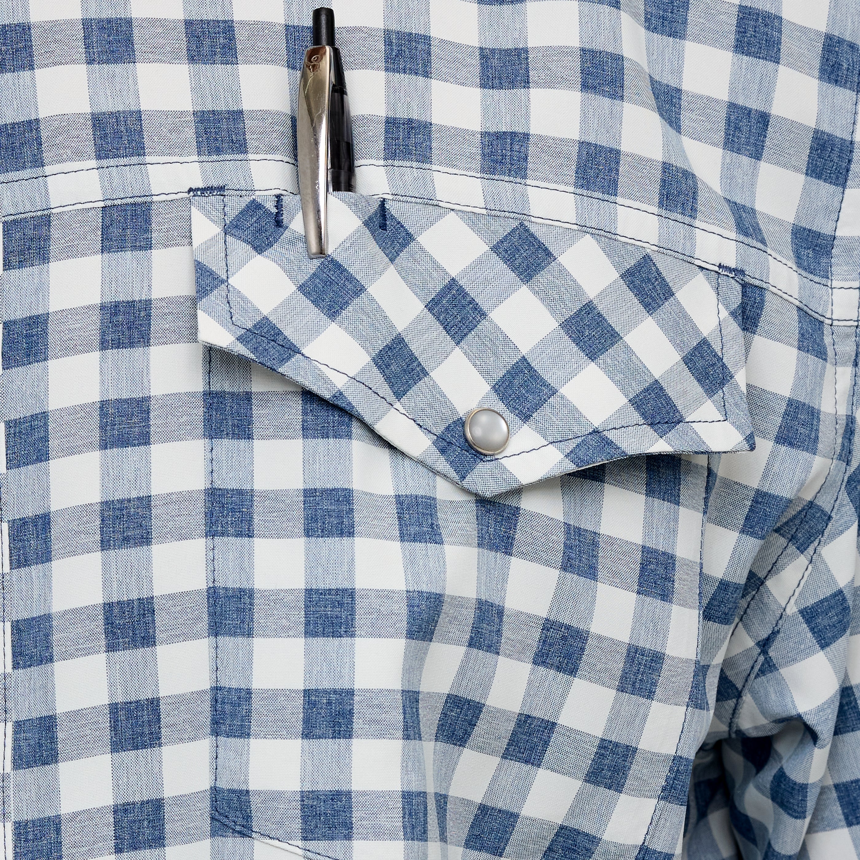 Blue and white checkered shirt with a button and pen in the pocket.