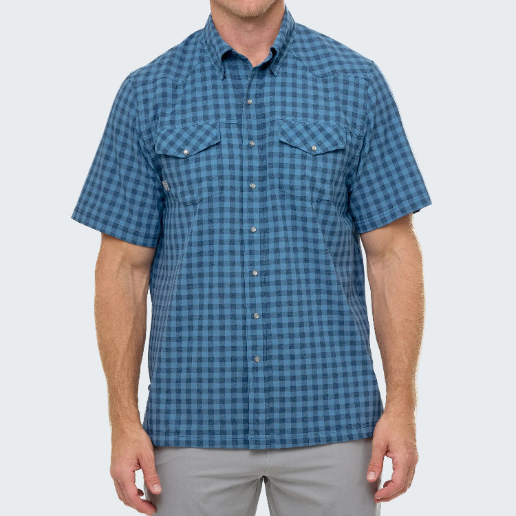 Man wearing a blue checkered short-sleeve shirt on a white background