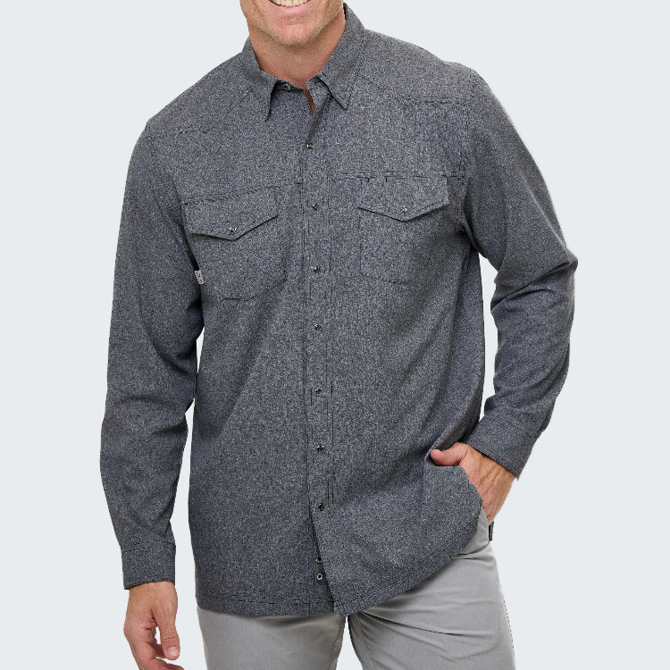 Man wearing a gray button-up shirt on a white background