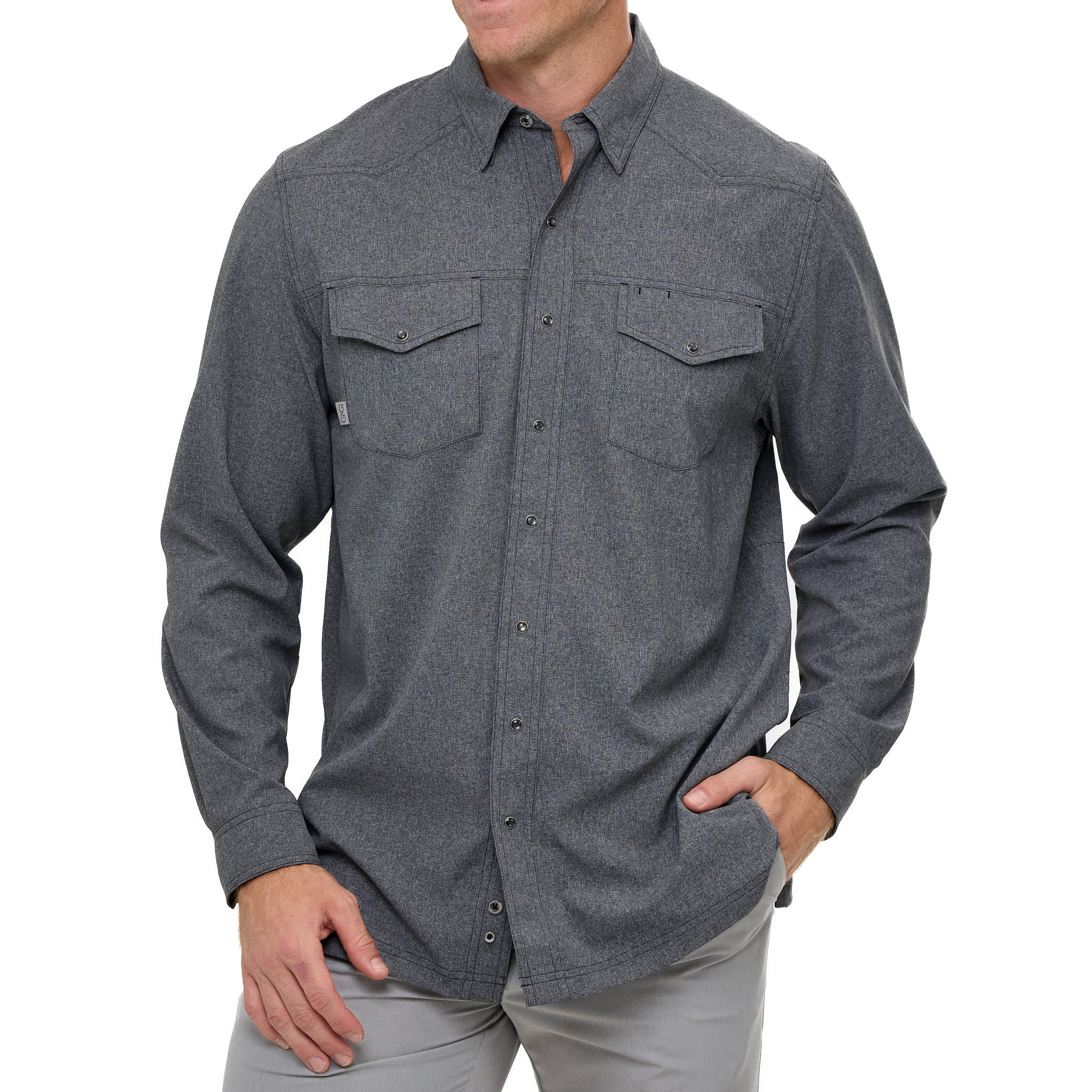 Man wearing a gray button-up shirt with two front pockets on a white background