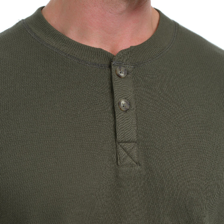 Close-up of a green long-sleeve shirt with buttons on a white background