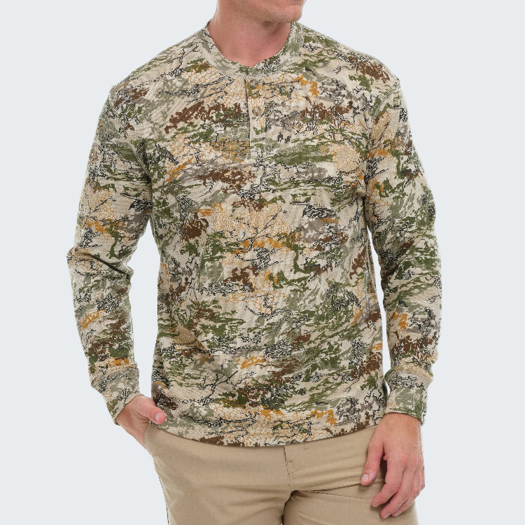 Camouflage long-sleeve shirt worn by a person on a white background