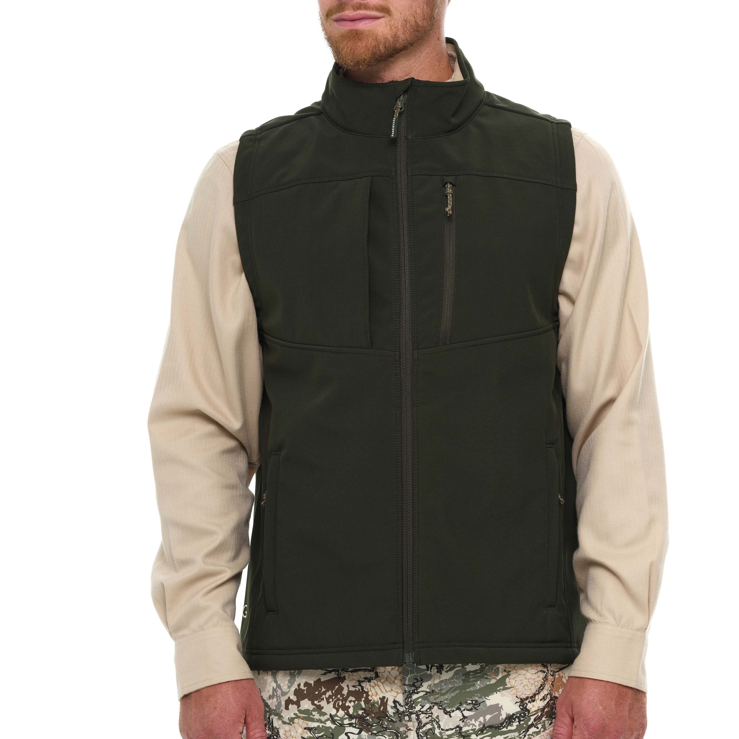Man wearing a black vest over a beige shirt on a white background