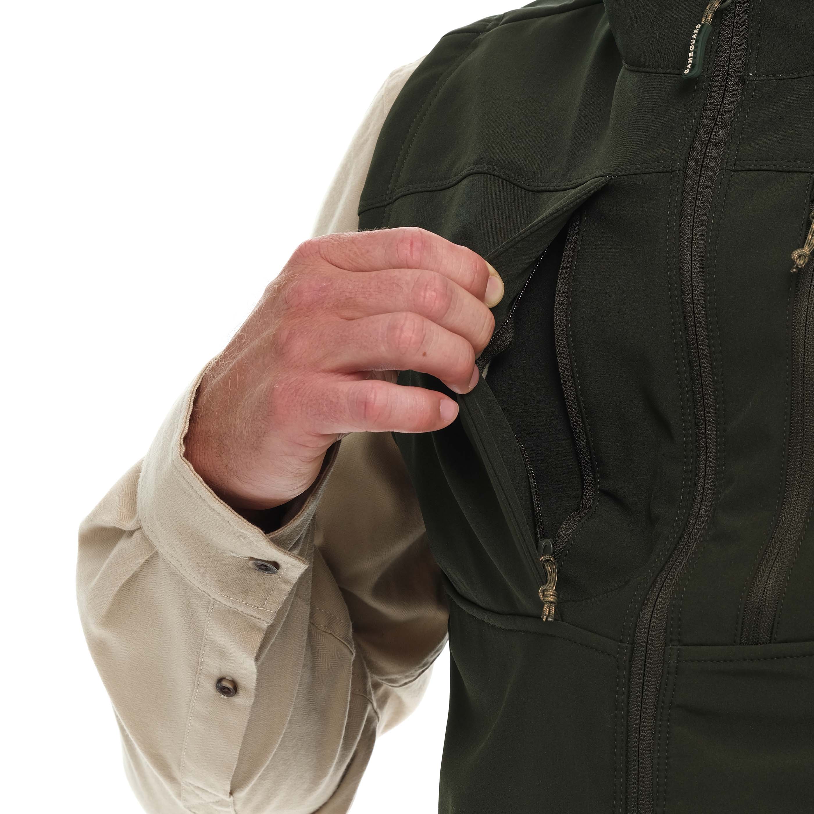 Person wearing a black jacket with a beige shirt underneath, on a white background