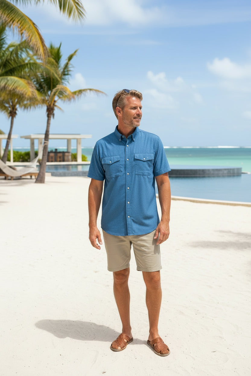 A blue short-sleeve button-up shirt with two chest pockets and a visible G-1000 logo on the left chest pocket, displayed flat against a white background.