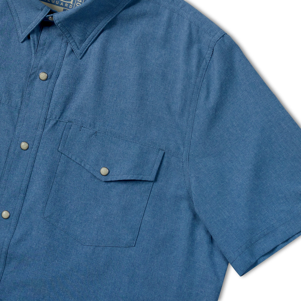 A close-up of a blue short-sleeve button-up shirt with a chest pocket, shown against a white background.