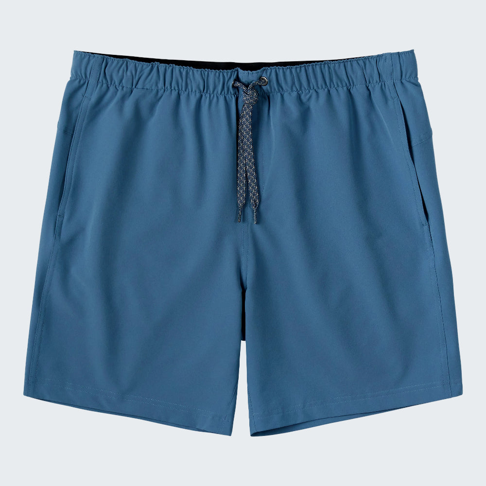 A pair of men's athletic shorts in a slate blue color, featuring an elastic waistband, a matching blue patterned drawstring, and side pockets, shown against a plain white background.