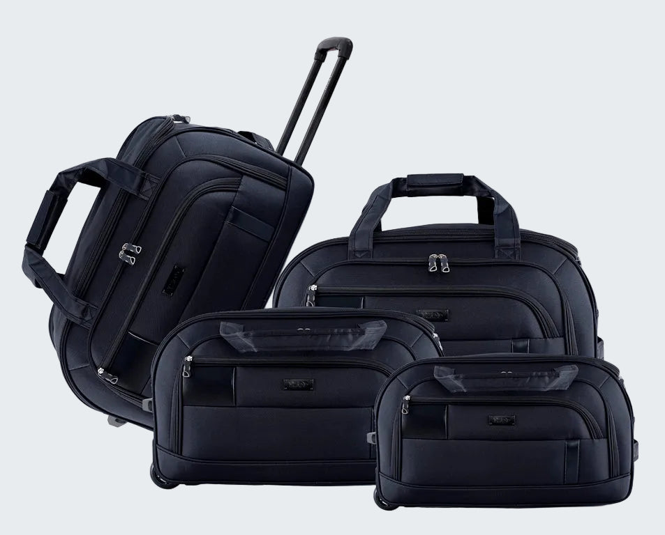Set of black suitcases including a backpack, duffel bag, and two rolling suitcases on a white background
