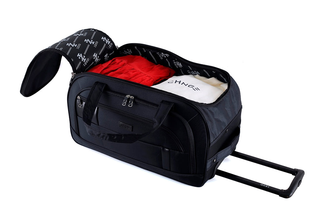 Black duffel bag with clothes on a white background