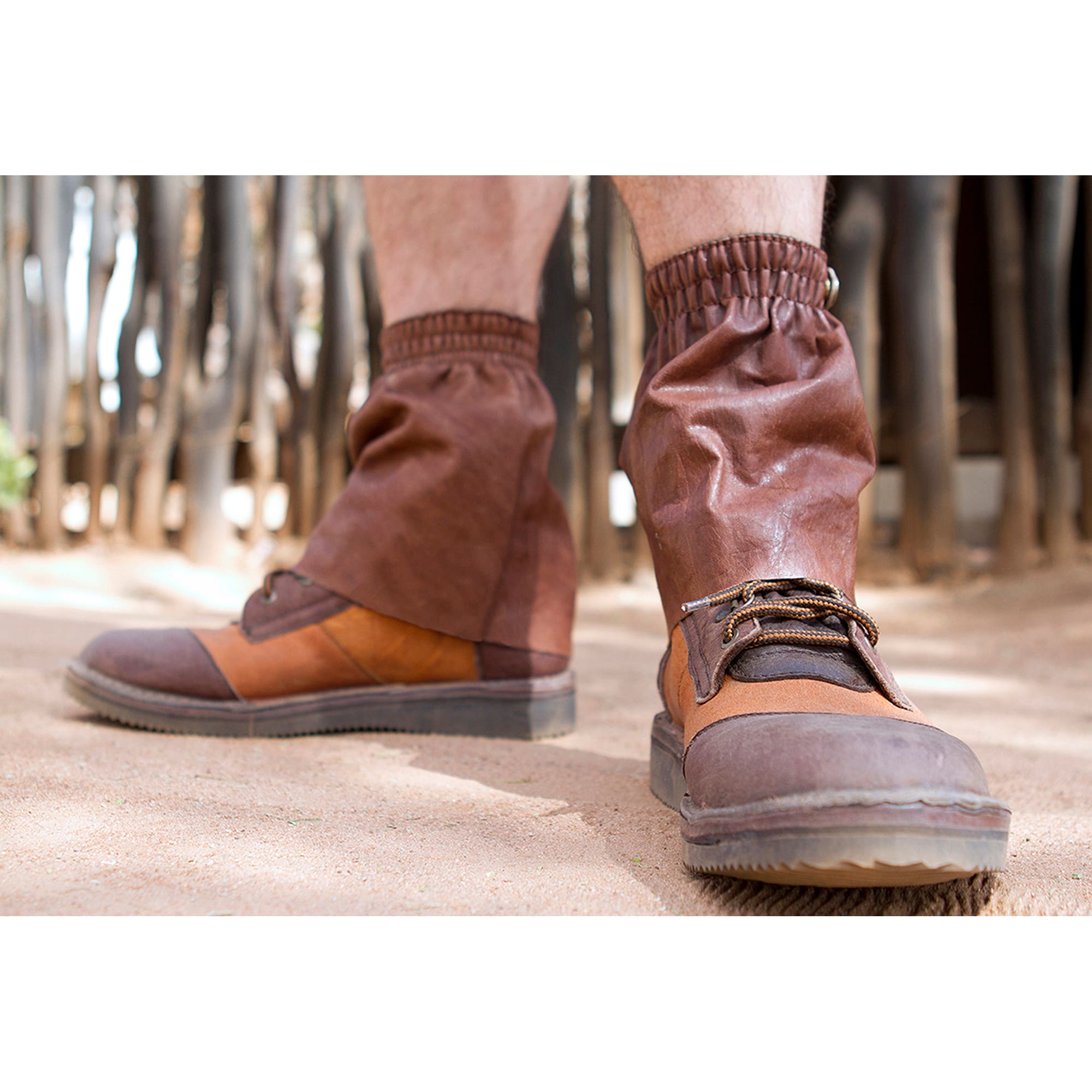 Brown leather boots with gaiters worn in a forest setting