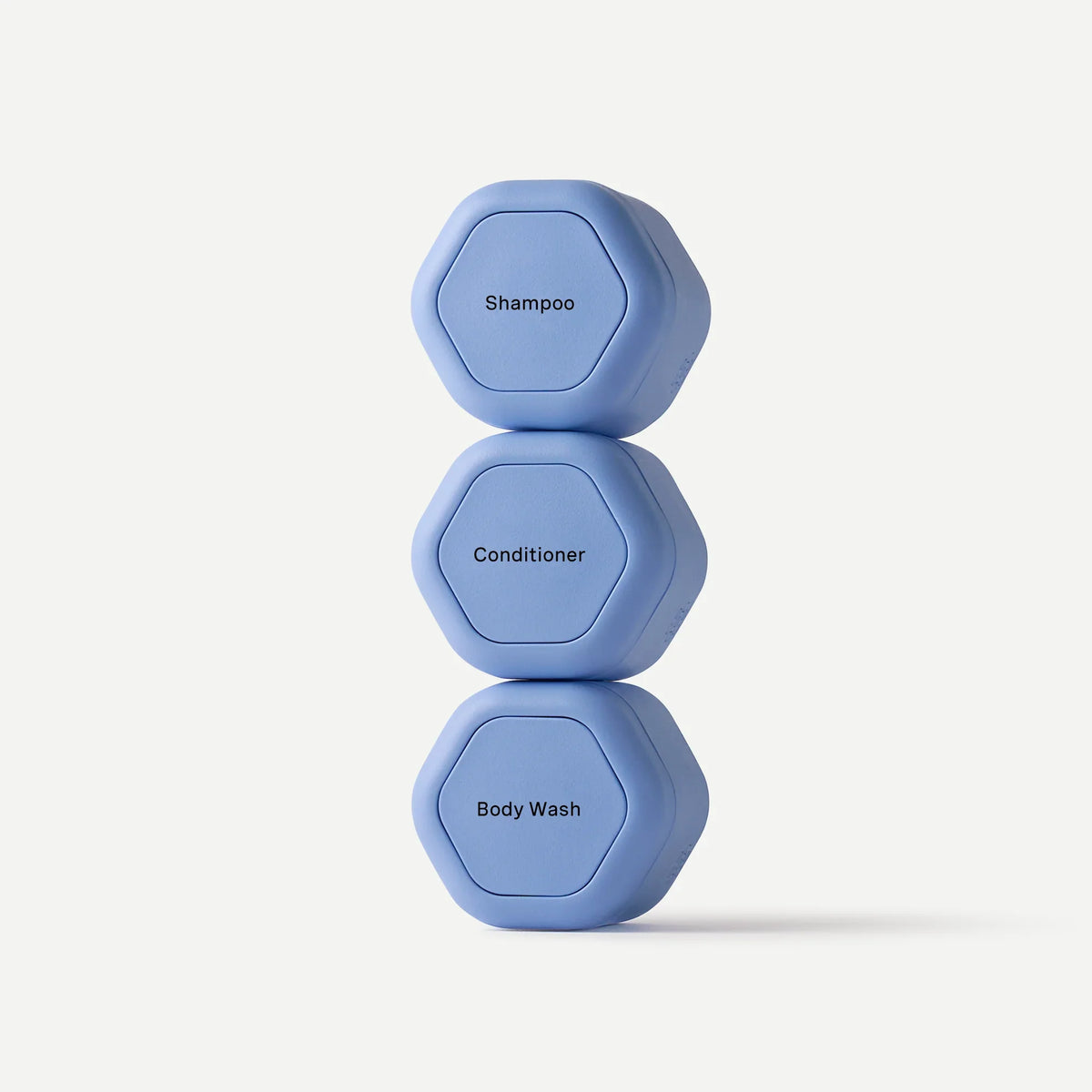 Three blue hexagonal weights stacked on a white background