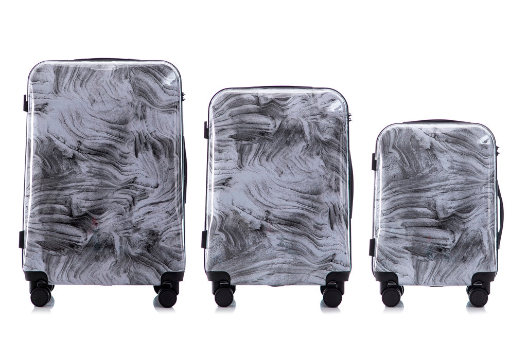 Set of three gray marbled suitcases on a white background