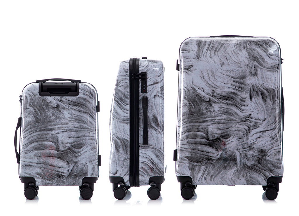 Set of three gray marble-patterned suitcases on a white background