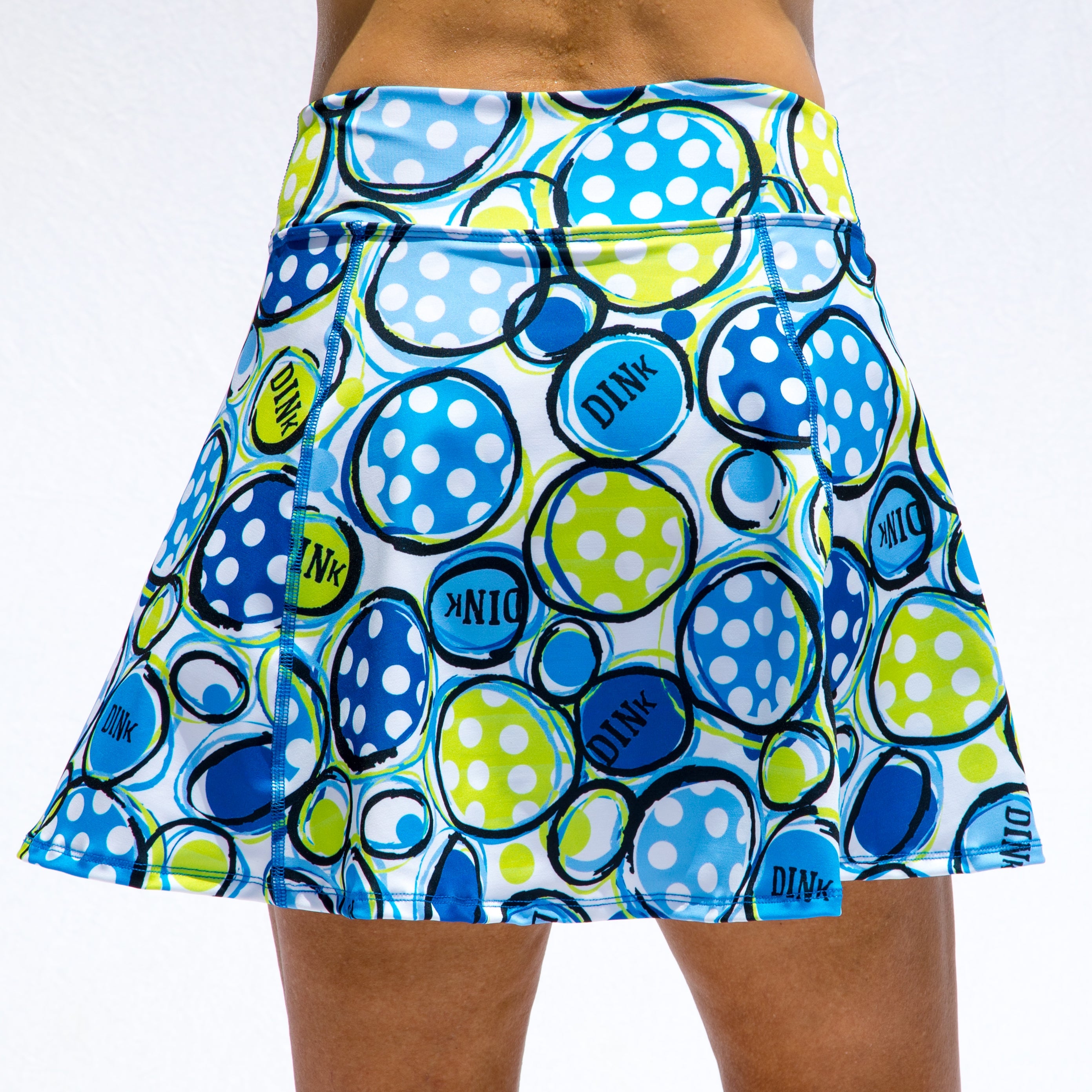 Colorful polka dot skirt with 'Dink' branding on a white background