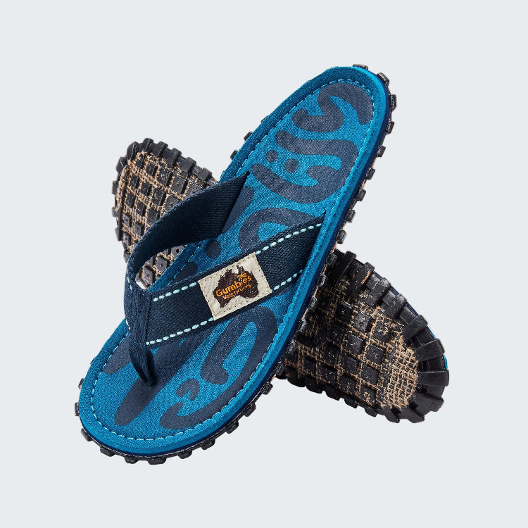 Blue flip-flop sandal with patterned sole on a white background