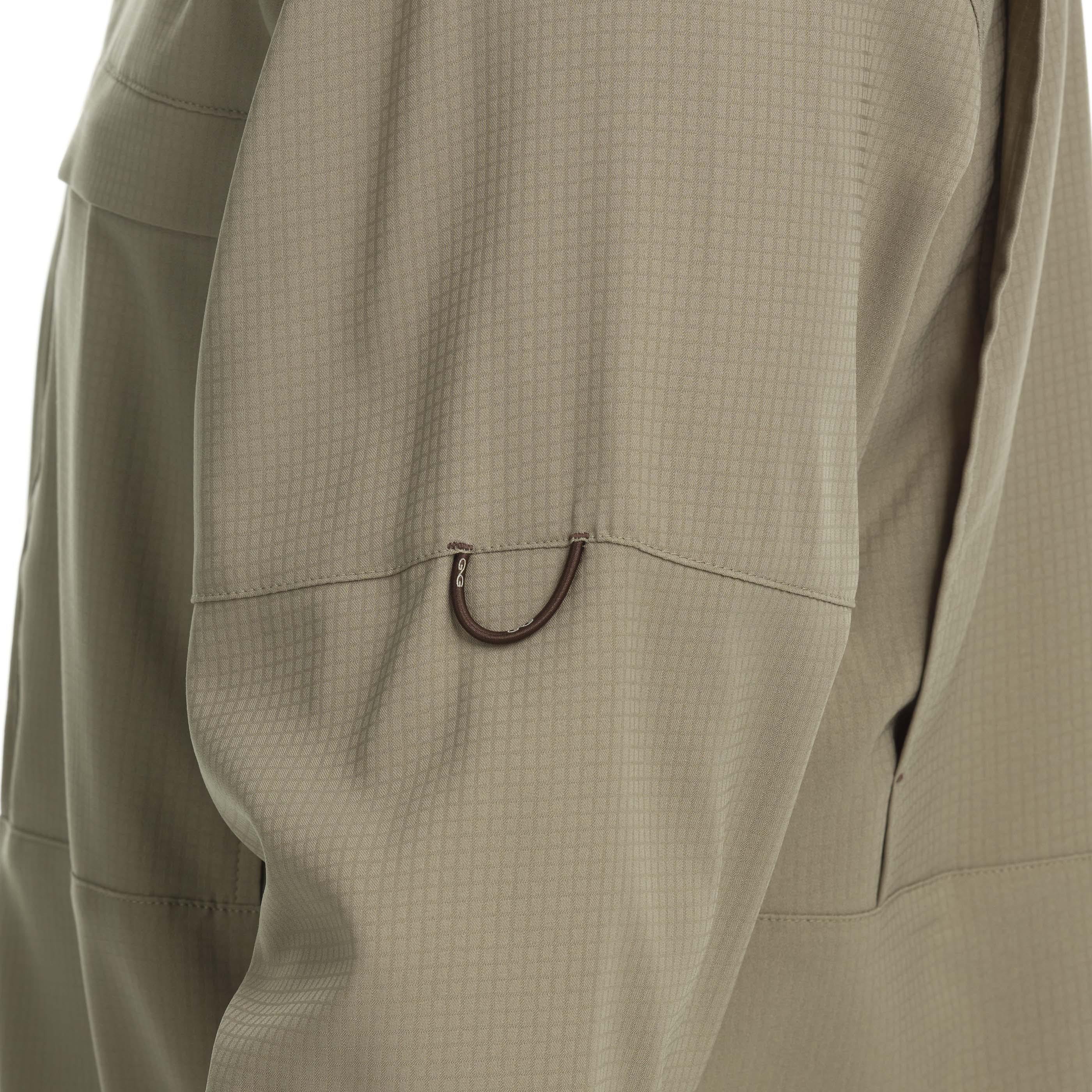 Close-up of beige pants with a pocket detail on a white background