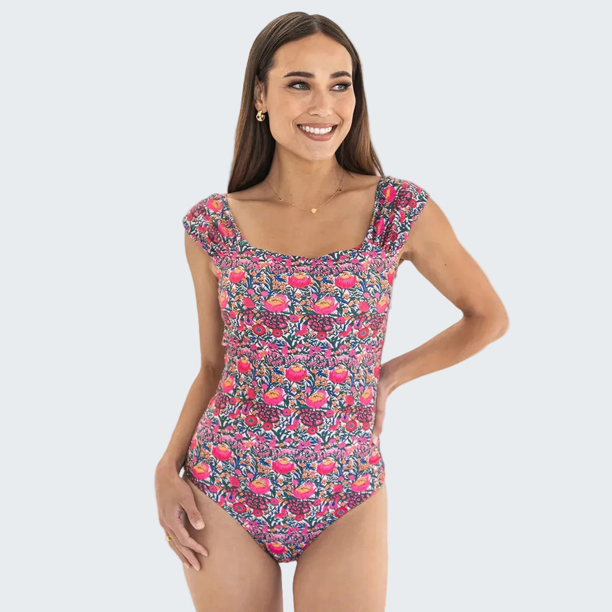 Woman wearing a floral one-piece swimsuit on a white background