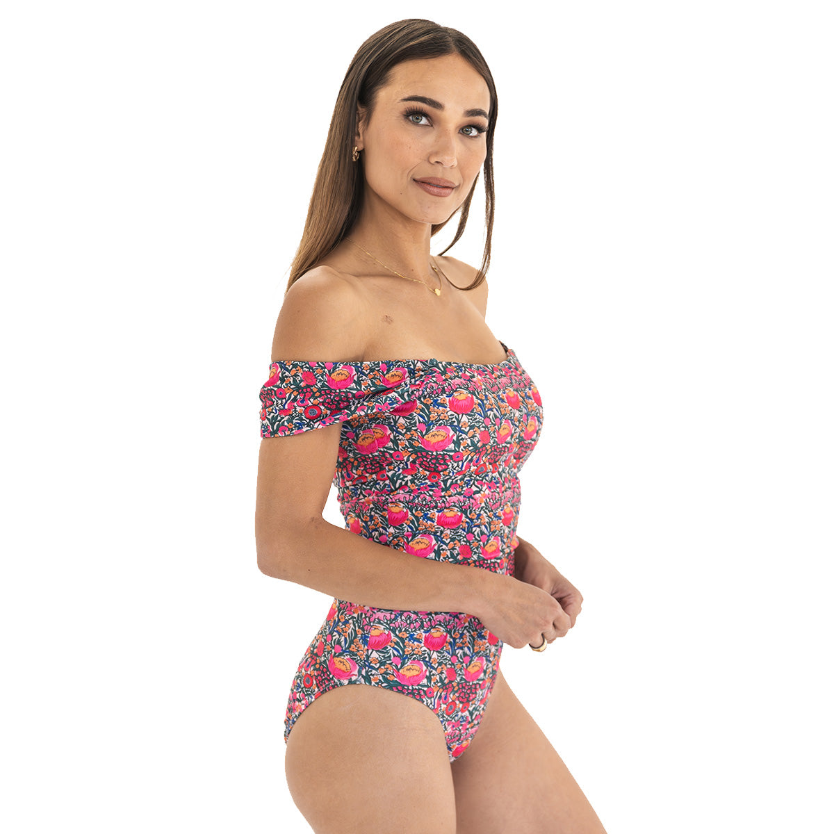 Woman wearing a colorful floral off-shoulder swimsuit on a white background