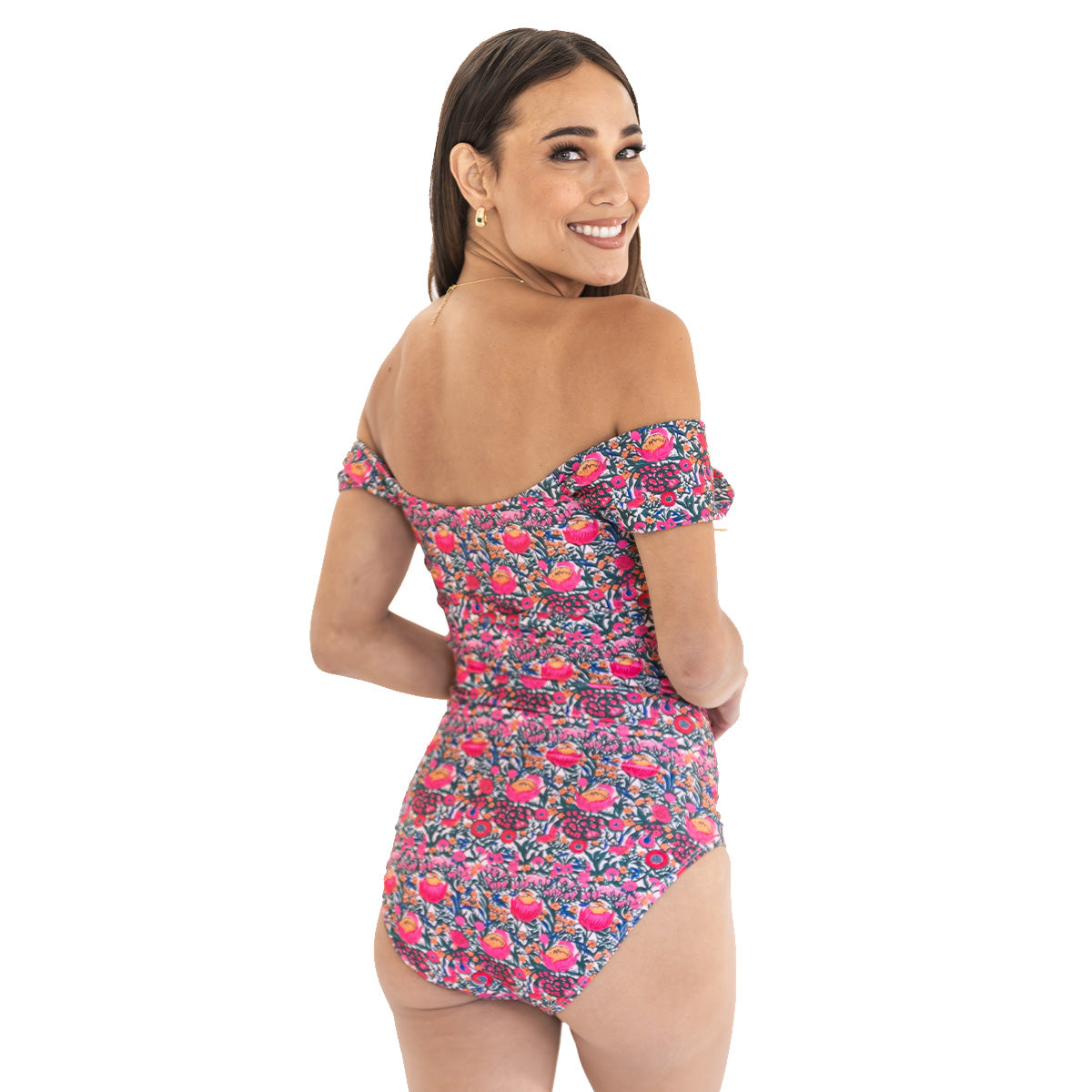Woman wearing a floral off-shoulder romper on a white background